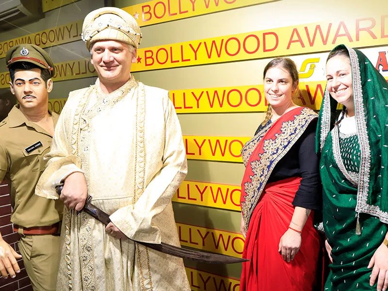 foreign tourists enjoying bollywood tour by sj studios in mumbai